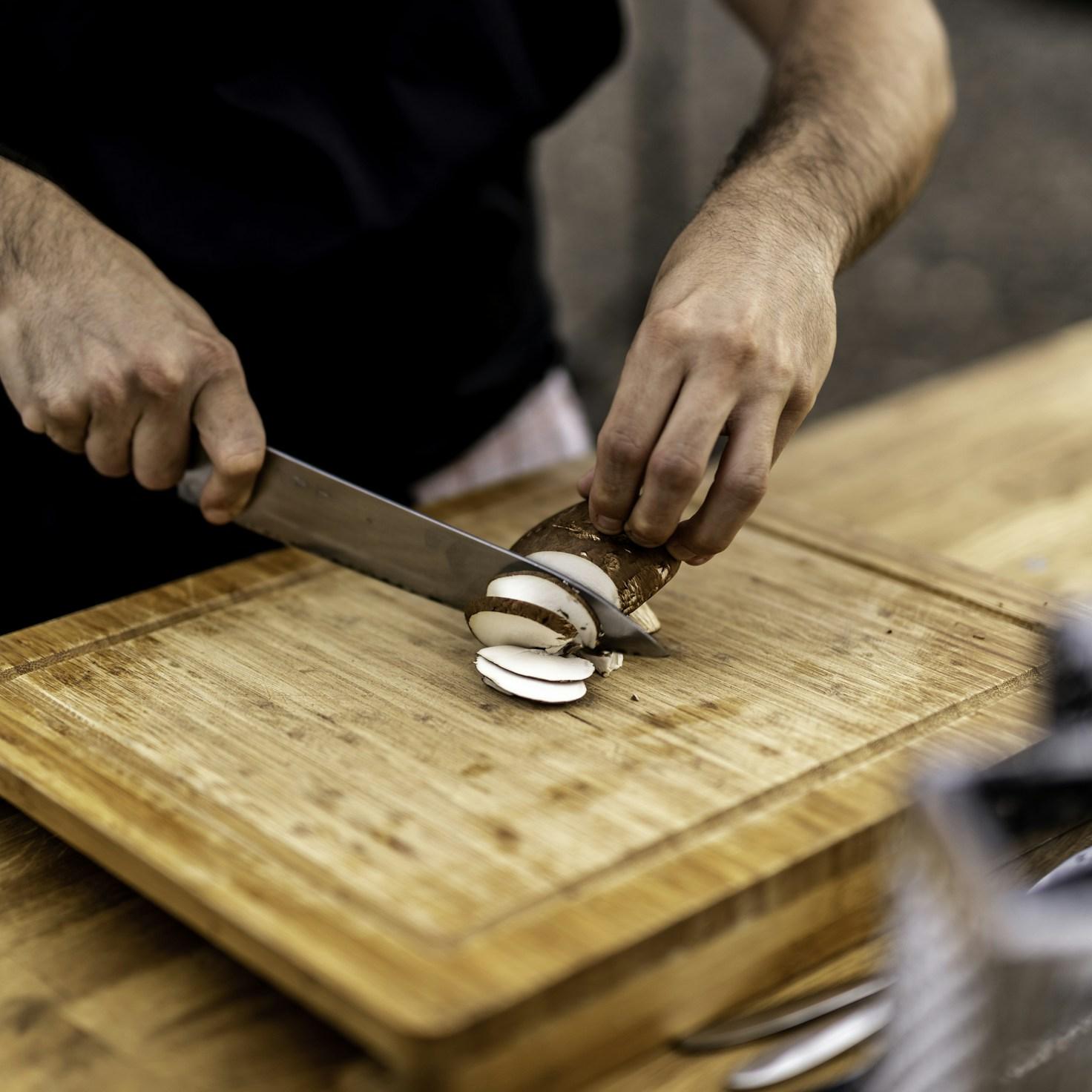 Community members collaborating in a modern kitchen space, sharing recipes and cooking techniques